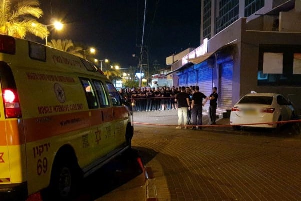 צילום באדיבות מד"א ) הרכב שנפגע ברצח הכפול וקהל הסקרנים בטירה)